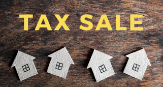 words tax sale in yellow with houses